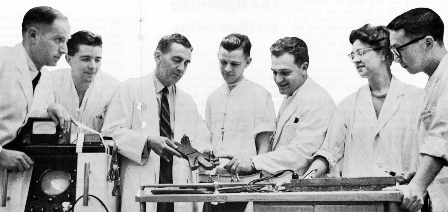 Dr. W.G. Bigelow and colleagues in hibernation research are grouped around an electro-cardiograph machine and cooling bath