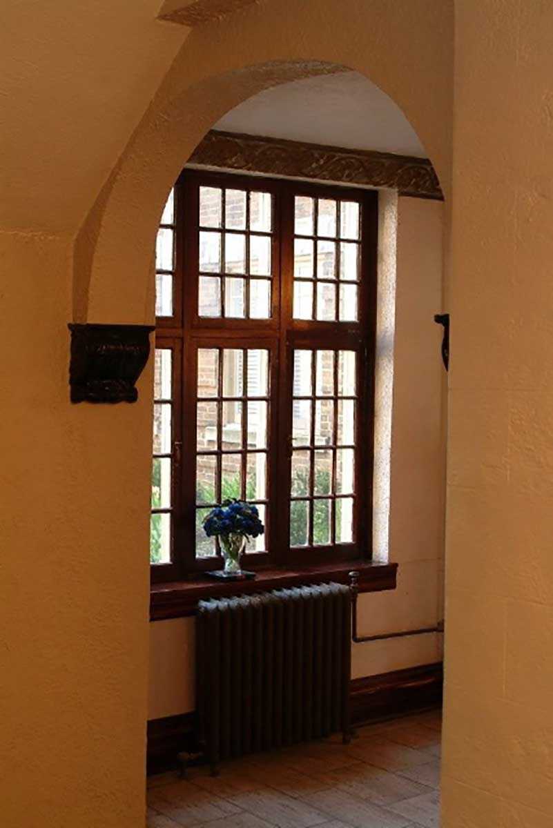 Restored wood-frame windows can provide superior R-value to more modern vinyl or aluminum replacements. (Shown here, the lobby of The Strathcona Apartments, 404 Laurier Avenue East, Ottawa.)